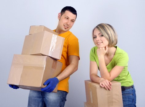 Professional movers handling furniture in a Canary Wharf high-rise